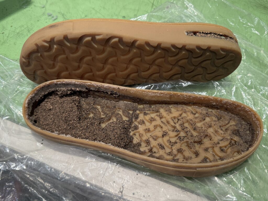 分解したソール内部のコルクが粉状に崩れている状態。外からは分からない劣化の進行を記録した工程写真。