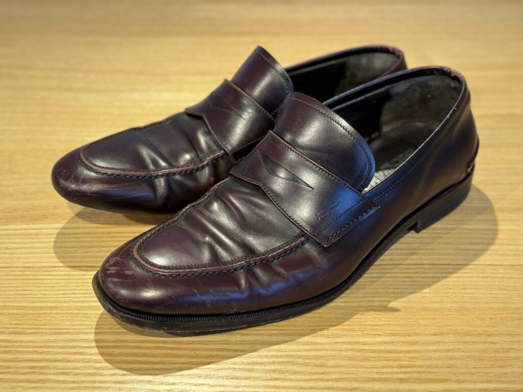 修理前のフェラガモローファー全体。アッパーの履きジワと色むらが見られる状態。